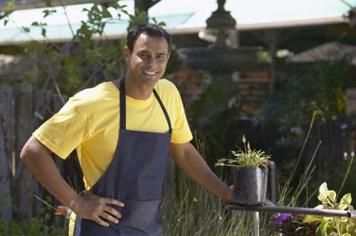 Gardener using hedge shears for precise trimming